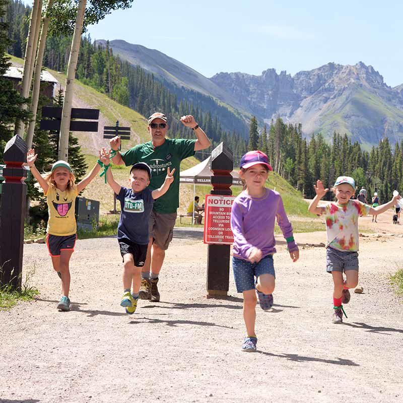Four kids and a counselor running in Telluride.