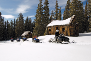 Snowmobiling tour amidst beautiful mountains in Telluride's Alta Lakes Ghost Town 