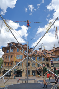 Little girl having fun on the spider jump offered in Mountain Village.
